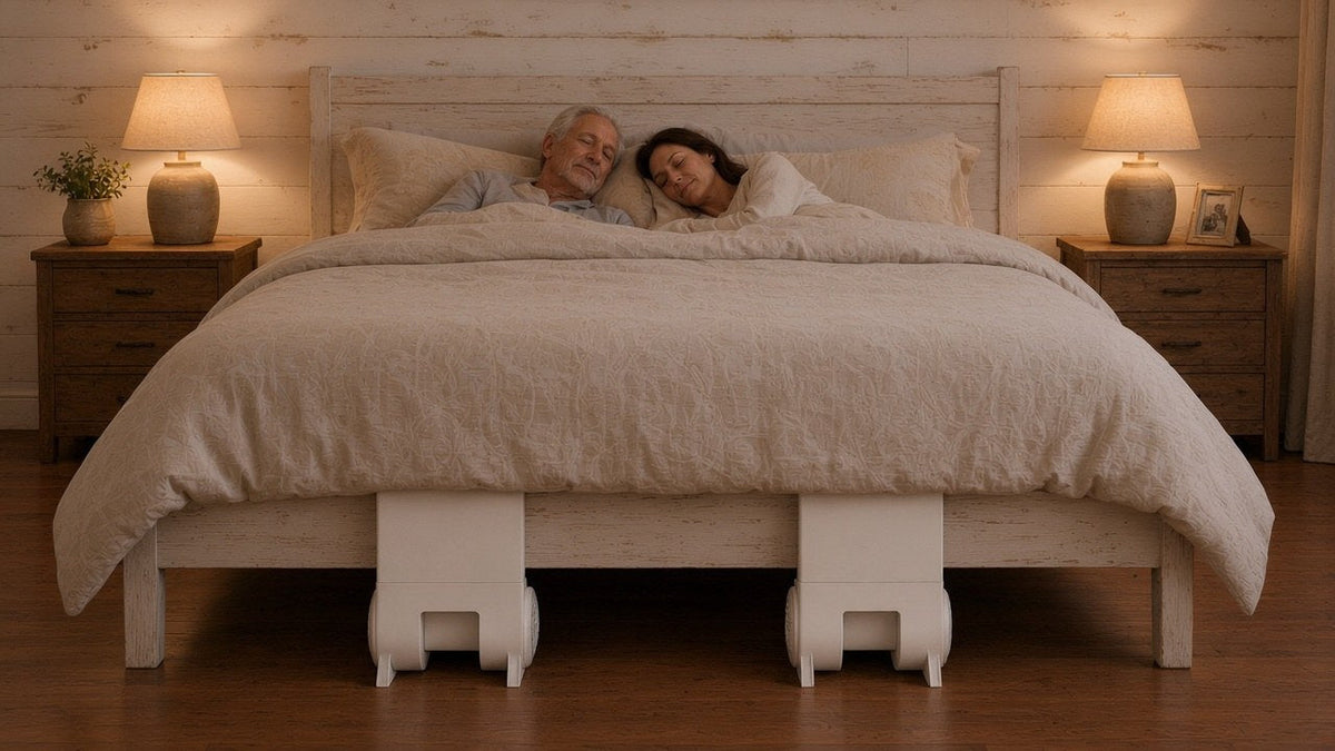 Bed cooling system comparison: two people asleep with two bFan bed fans at the foot of the bed, one for each side